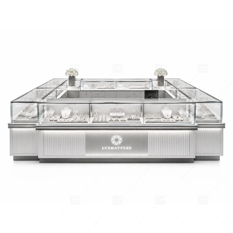 Silver Rounded Jewelry Kiosk with Glass Cases brand signage detail for minimal logo sign and clean silver branding coordinated with silver trim and neutral surfaces for a clean modern retail image for the silver rounded jewelry kiosk with glass cases front presentation